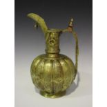 A Khorasan brass ewer, the lobed body and flared neck engraved with foliate and script panels within