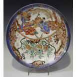 A Japanese Imari porcelain circular dish, Meiji period, painted with panels of figures, quail,