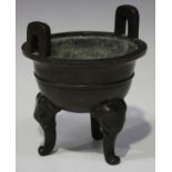 A Chinese brown patinated bronze censer, late Qing dynasty, the circular body with ribbed girdle