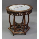 A Chinese hardwood circular centre table, early 20th century, the circular top inset with a grey