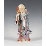 A Chinese famille rose enamelled porcelain figure of Shoulau, 20th century, modelled wearing a