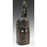 A group of African carved wooden items, comprising a pair of kneeling figures, heights 47cm and