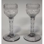 A pair of faceted stem wine glasses, late 18th century, the rounded bowls cut with alternating