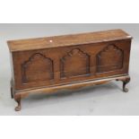 A 19th century oak triple panel side cabinet with hinged lid, on cabriole legs, height 54cm, width
