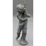 An early 20th century lead garden fountain figure of a standing putto holding a pike, height 98cm.