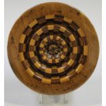 A 19th century olive wood turned circular snuff box, the lid with alternating inlaid concentric