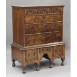 A George I walnut chest-on-stand, the moulded pediment above three short and three long drawers, the