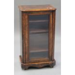 A late Victorian burr walnut music cabinet with satinwood stringing, enclosed by a glazed door