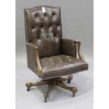 An early 20th century walnut and buttoned brown leather revolving office chair, height 110cm,