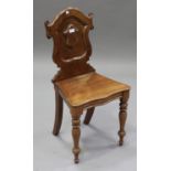 A late Victorian mahogany shield back hall chair with solid seat, on turned baluster legs, height