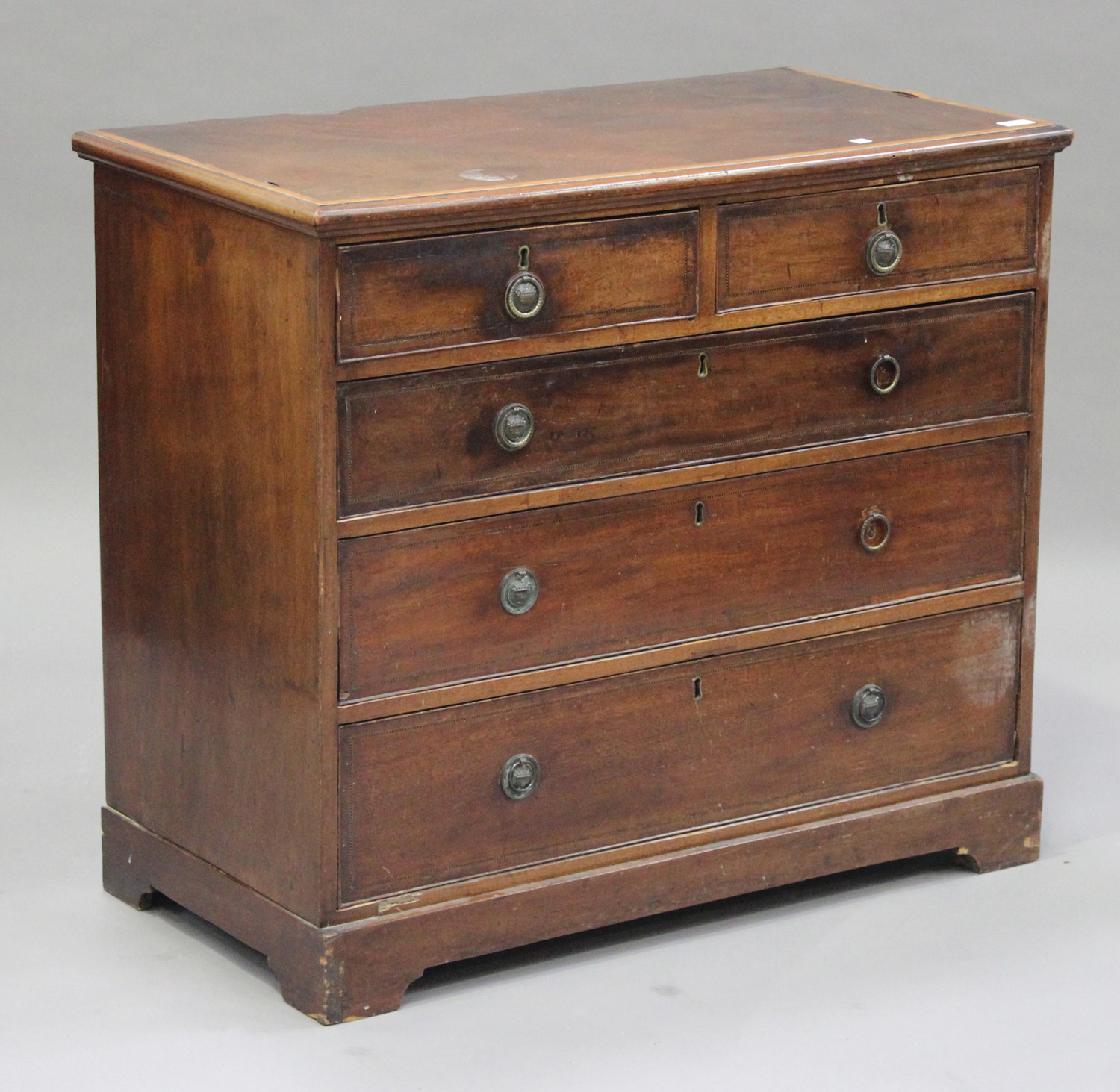 A Victorian mahogany chest of two short and three long drawers, with chequer stringing, on bracket