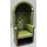 A late 20th century buttoned green leather porter's chair, the hooded arch top above scroll arms,