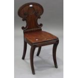 A Regency mahogany hall chair with carved scroll decoration, on sabre legs, height 82cm, width