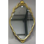 An early/mid-20th century gilt composition wall mirror, the shaped frame with a shell crest, 101cm x