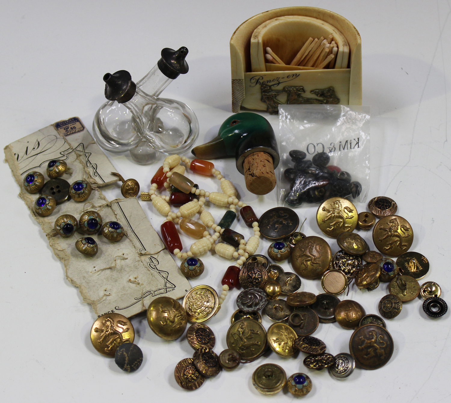 A small group of collectors' items, including an assortment of buttons, some military, a silver