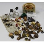 A small group of collectors' items, including an assortment of buttons, some military, a silver