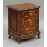 A late 20th century hardwood bedside chest of three drawers with carved decoration, on scroll