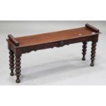 An early Victorian mahogany window seat, raised on bobbin turned legs, height 46cm, width 107cm,