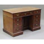A Victorian mahogany twin pedestal desk, the crossbanded top above an arrangement of nine drawers