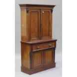 A Victorian mahogany bookcase cabinet, the moulded pediment above a pair of panel doors, the base