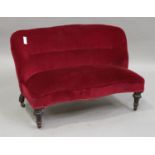 A late Victorian two-seat settee, upholstered in red velour, raised on turned legs, height 72cm,