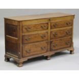 An George III oak mule chest, the hinged lid above mahogany crossbanded dummy drawers and two base