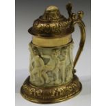 A gilt metal mounted ivory tankard, the 18th century ivory body carved in relief with a continuous