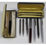 A group of fountain pens, including a Parker 61, cased, another Parker, a Sheaffer ballpoint and