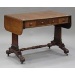 An early Victorian mahogany sofa table, fitted with three drawers, raised on scroll feet and