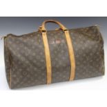 A Louis Vuitton Keepall 55, the monogram canvas body with tan leather trimming and handles, length