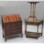 A 20th century George III style mahogany bureau, the fall front above three long drawers, on