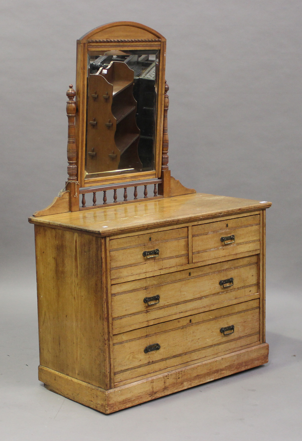 A late Victorian ash swing frame dressing chest of two short and two long drawers, on a plinth base,