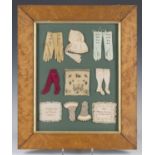 A group of Victorian miniature needlework items, comprising three pairs of gloves, a bonnet, two