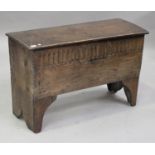 A late 17th century oak six plank coffer, the hinged lid and front with notched edges, carved with a