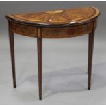 A 19th century figured mahogany and satinwood inlaid demi-lune fold-over card table, the hinged