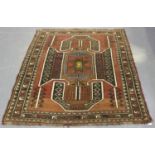 A Turkish 'Kazak' design rug, mid-20th century, the shaded claret field with a large shaped