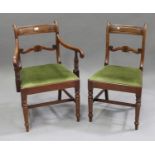 A set of seven George III mahogany bar back dining chairs with shell and 'S' scroll centre rails,