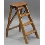 A 20th century pine folding four-rung stepladder, height 76cm, width 38cm, depth 64cm.Buyer’s