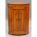 An Edwardian Neoclassical Revival satinwood bowfront corner cabinet with inlaid decoration, fitted