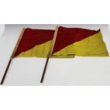A pair of signalling flags, the linen formed as red and yellow triangles, each flag 39cm x 49cm.