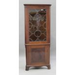 An Edwardian mahogany floor standing corner cabinet, raised on shaped bracket feet, height 200cm,