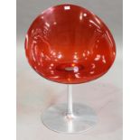An Italian 'Eros' swivel chair designed by Philippe Stark for Cartell, the orange plastic seat on