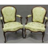 A pair of early/mid-20th century French Rococo Revival walnut showframe fauteuil armchairs,