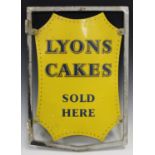 An early/mid-20th century 'Lyons Cakes Sold Here' double-sided tin advertising sign, the shaped