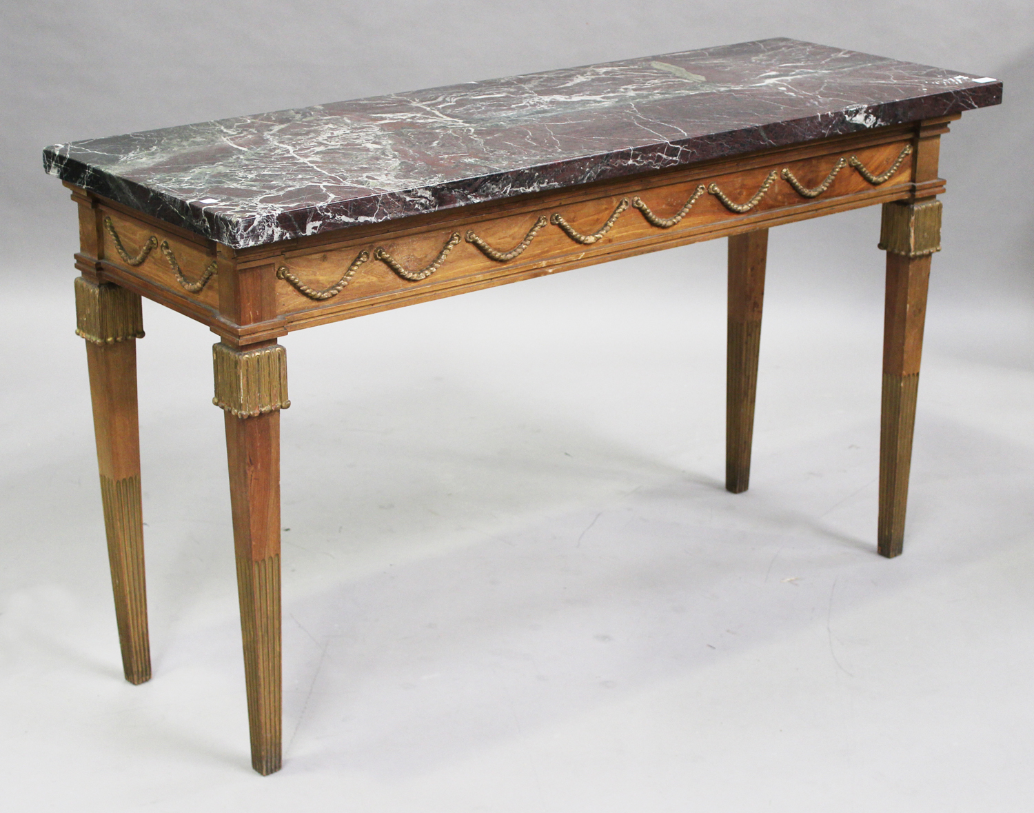 A 20th century French Louis XVI style parcel gilded beech and marble-topped console table, the