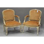 A pair of early 20th century French limed beech fauteuil armchairs with carved decoration,