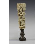 A 19th century ivory handled desk seal, finely carved with overall trailing vine leaves and