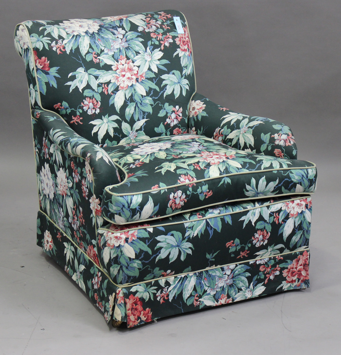 A 20th century Howard style armchair with curved scroll arms, height 88cm, width 79cm.Buyer’s