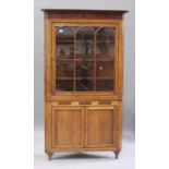 A George III Lancastrian oak corner cabinet, crossbanded in mahogany, the moulded pediment above a