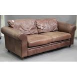 A modern brown leather two-seat sofa, on turned feet, height 75cm, width 210cm, depth 96cm.Buyer’s